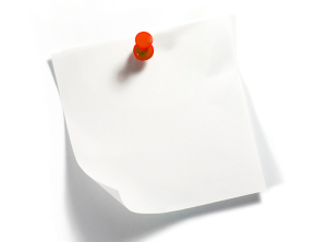 A white post it note with red pin