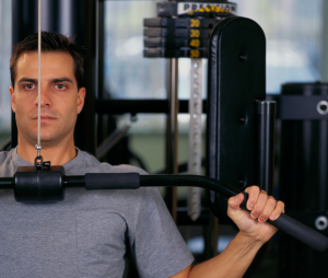 Man using pull down weights