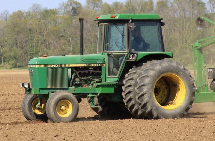 A John Deere tractor in a muddy field