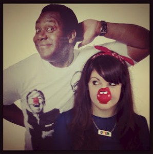 Blogger CTS with a red nose on standing in front of a picture of Lenny Henry.